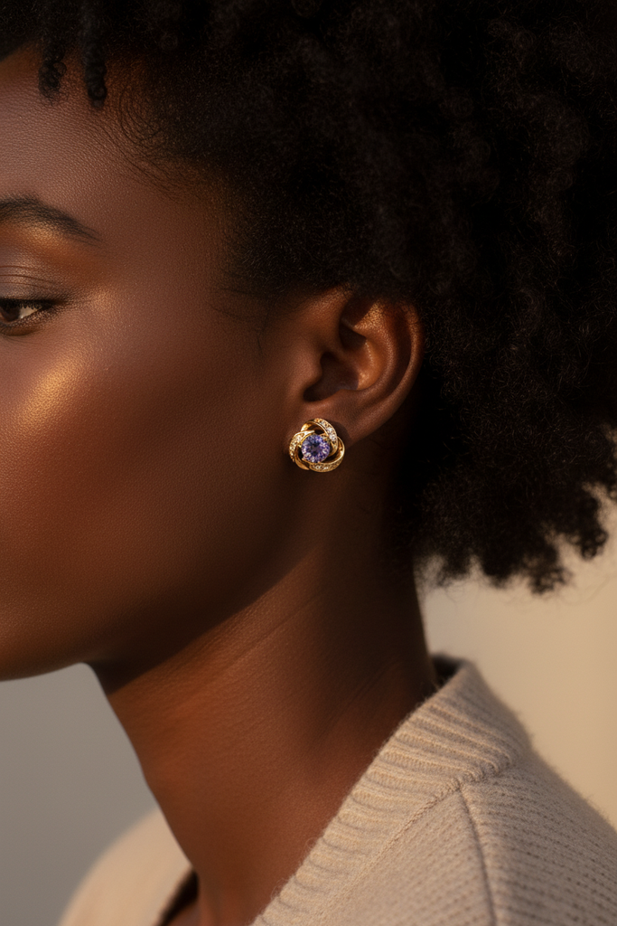 Langlet gold-plated purple crystal knot stud earrings worn on ear, lifestyle shot