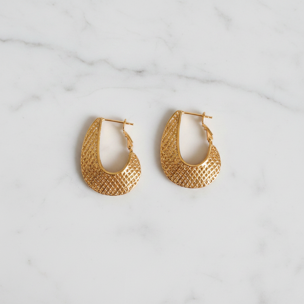 Quinn gold filigree caged hoop earrings flat lay on white marble