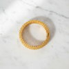 Alessia gold filigree lattice bangle bracelet flat lay on white marble