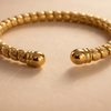 Liya textured beaded gold open cuff bracelet close-up coiled bead and ball end cap detail