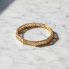 Charlotte gold octagonal quatrefoil filigree bangle flat lay on white marble