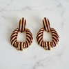 Riley burgundy gold stripe statement earrings flat lay on white marble
