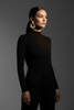 Riley black gold stripe statement earrings styled with sleek all-black outfit