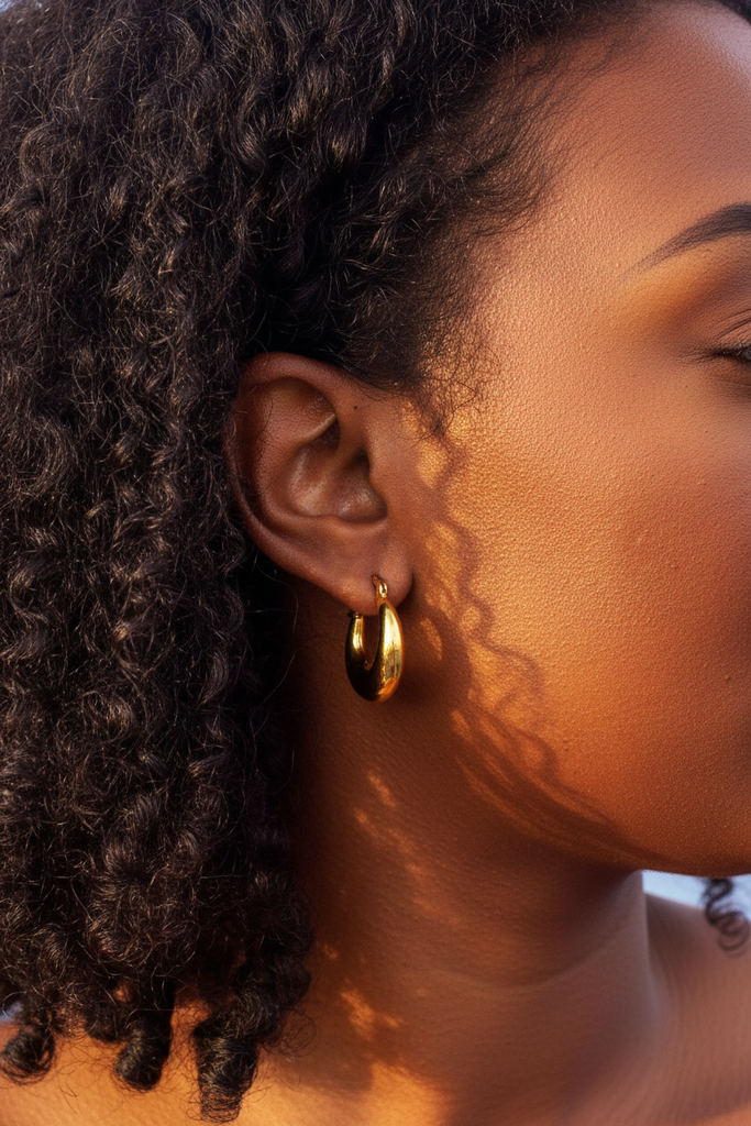Dyani chunky gold crescent hoop earrings side profile on-ear lifestyle shot