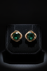 Kensington oversized green emerald stud earrings on dark velvet tray
