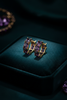 Kennedy purple amethyst stone huggie hoop earrings on dark velvet tray
