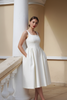 Ezra White Pleated Day Dress - white columns hands in pockets red lips