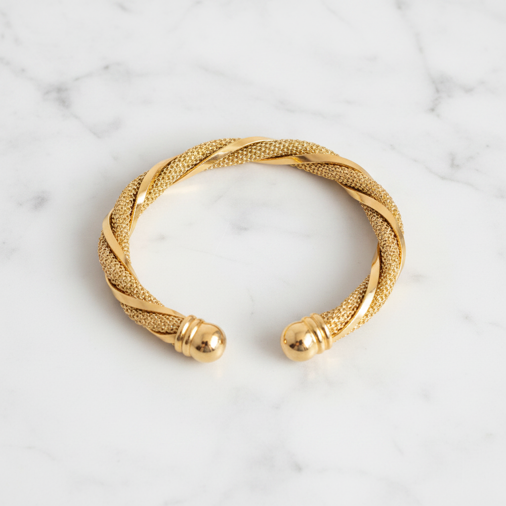 Worthington twisted gold mesh cuff bracelet flat lay on white marble