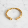 Worthington twisted gold mesh cuff bracelet flat lay on white marble