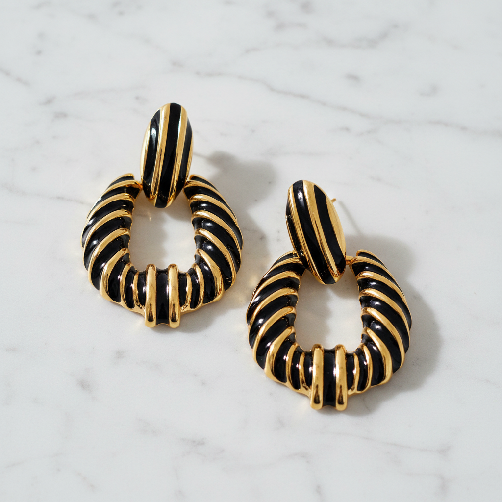 Riley black gold stripe statement earrings flat lay on white marble