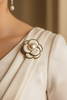 Ivory petal pearl bloom brooch pinned on bridal wedding dress