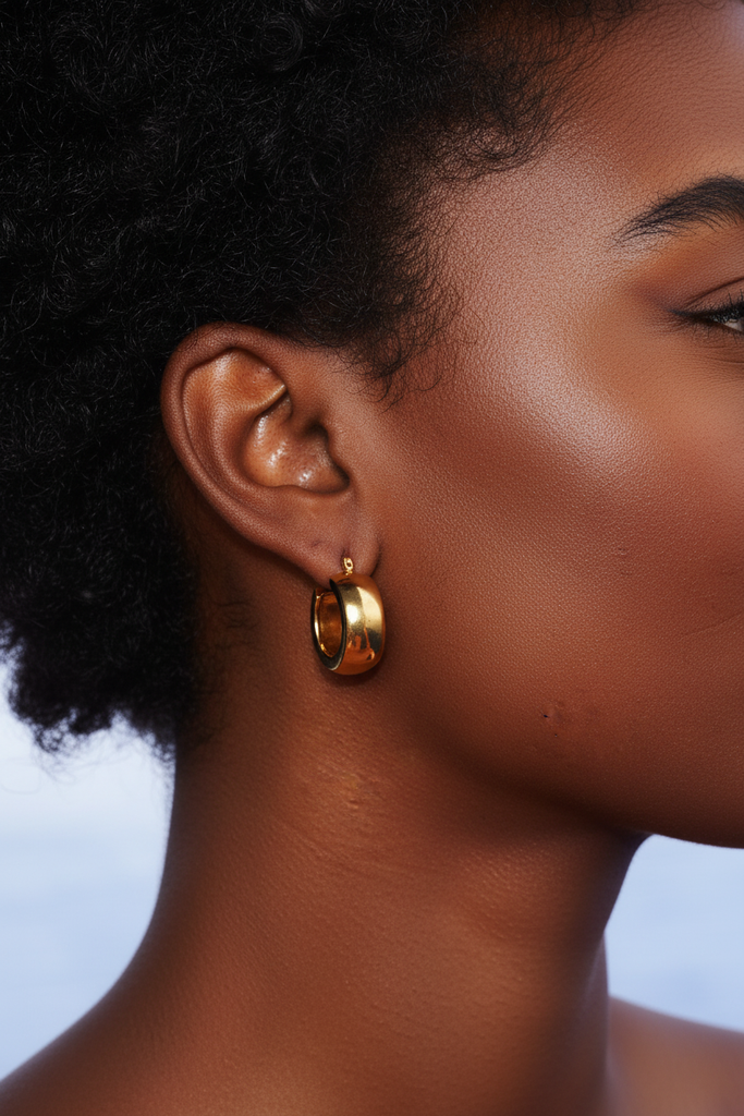 Aponi thick gold hoop earrings on-ear lifestyle editorial shot