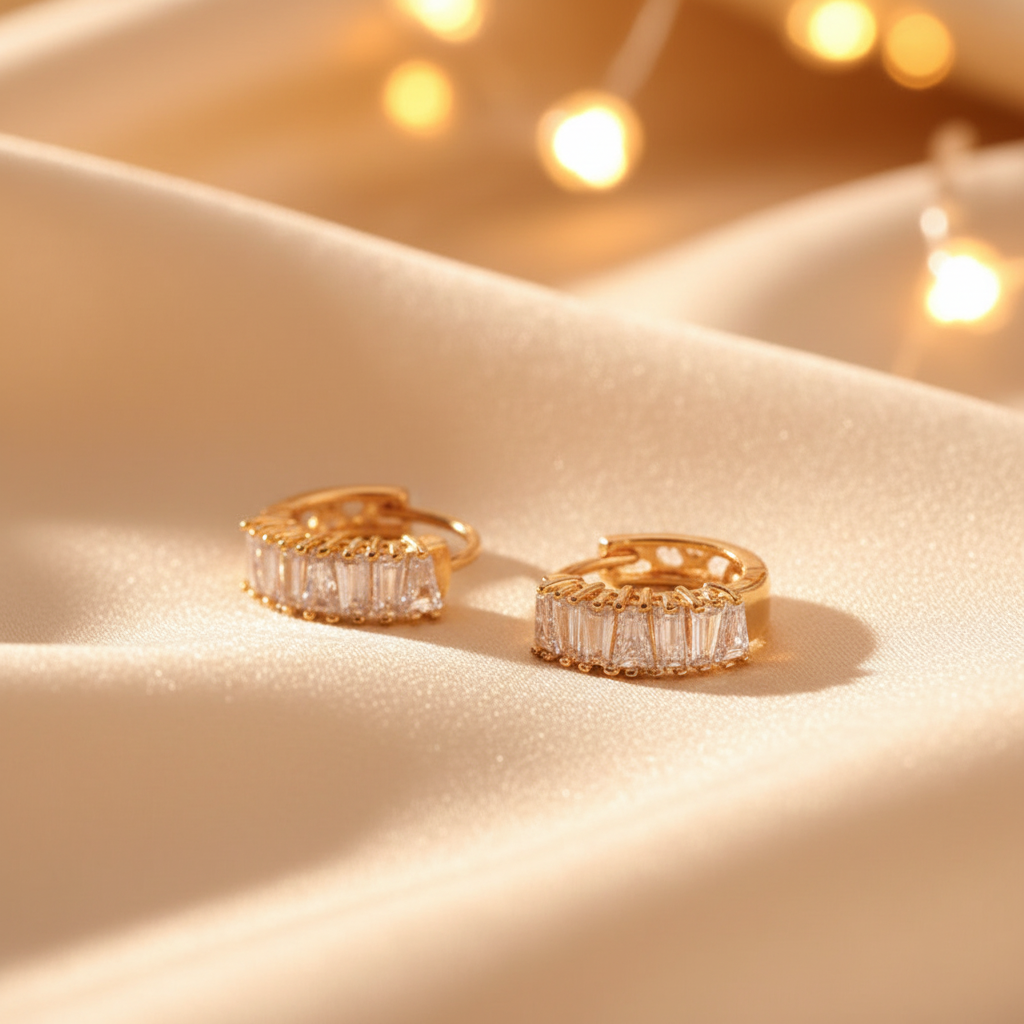 Capri gold plated baguette huggie earrings on cream silk gift display