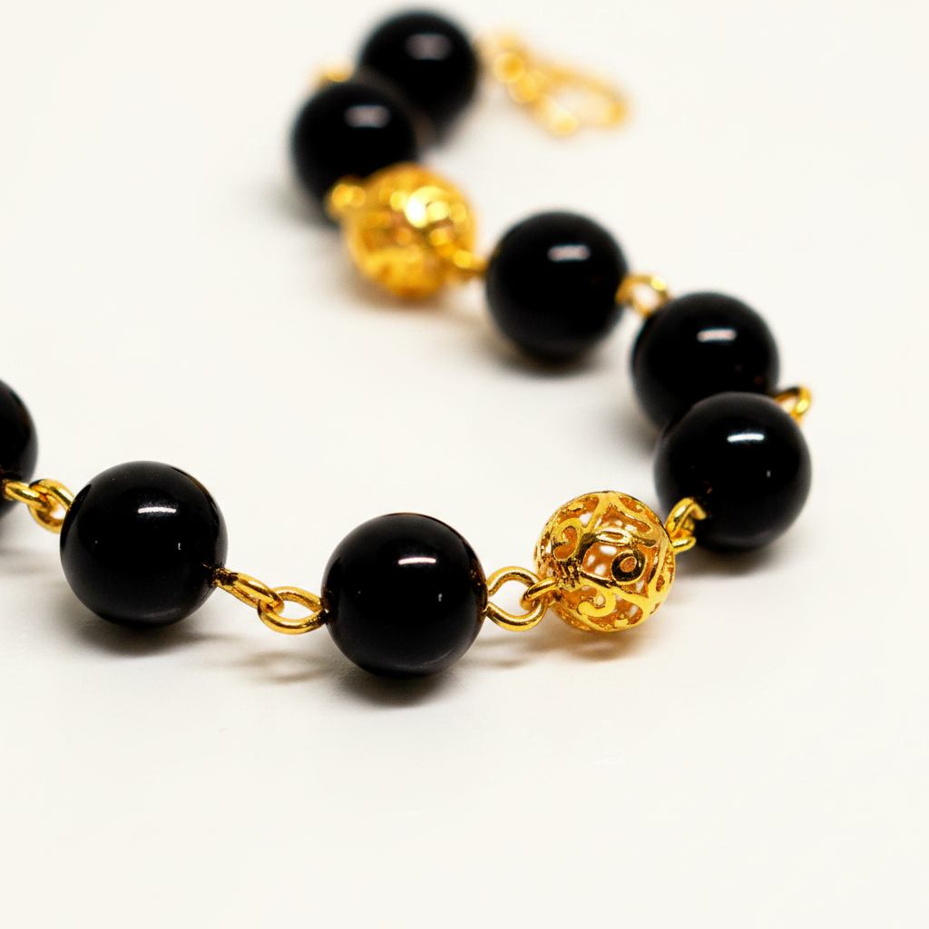 Elizabeth black resin and gold filigree ball bracelet close-up detail