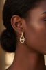 Addison gold diamond drop earrings on-ear lifestyle editorial shot