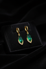 Sawyer emerald drop earrings on dark velvet tray