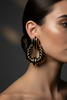 Riley black gold stripe statement earrings on-ear lifestyle shot