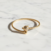 Celeste gold cat head cuff bracelet flat lay on white marble