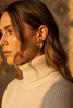 Kilgory gold swirl statement earrings on-ear lifestyle shot