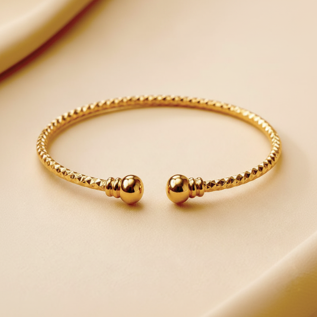 Kennedy gold twisted rope cuff bracelet close-up texture and ball end detail