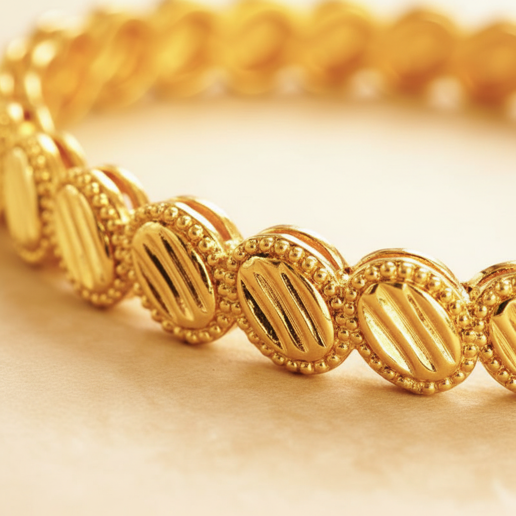 Ghana gold plated medallion bangle close-up diagonal ridged oval medallion detail