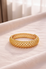 Alessia gold filigree lattice bangle bracelet on cream velvet tray