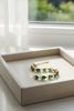 Adjua pear shape emerald tennis bracelet cream velvet tray display