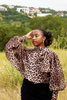 Thema Leopard Top - hand raised lush green outdoor field
