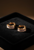 Capri gold plated baguette huggie earrings on dark velvet jewelry tray