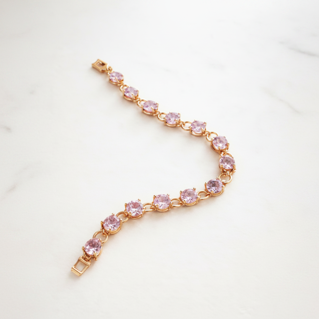 Winthrop tennis bracelet gold and pink oval-cut stones flat lay on white marble